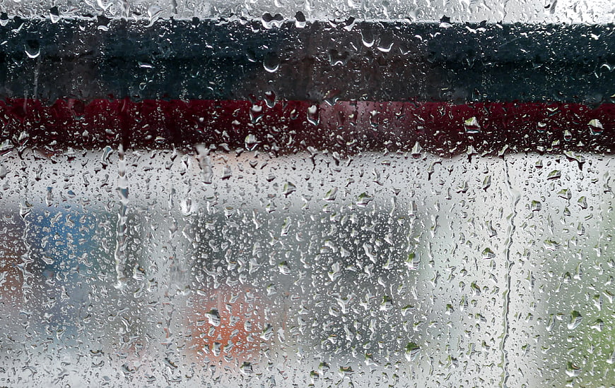 Raindrops on Window Glass with Blurred Urban Background