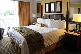 Cozy Hotel Guest Room With King Bed And Tropical Decor