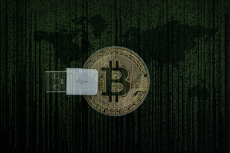 Bitcoin Coin And USB Drive On Digital Matrix Background