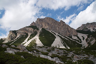 Majestic Dolomites Mountain Peak with Snow Patches and Blue Sky