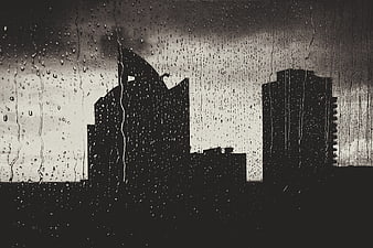 Raindrops on Window with City Skyline Silhouette