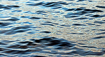 Close-up of rippling blue water surface with sunlight reflections