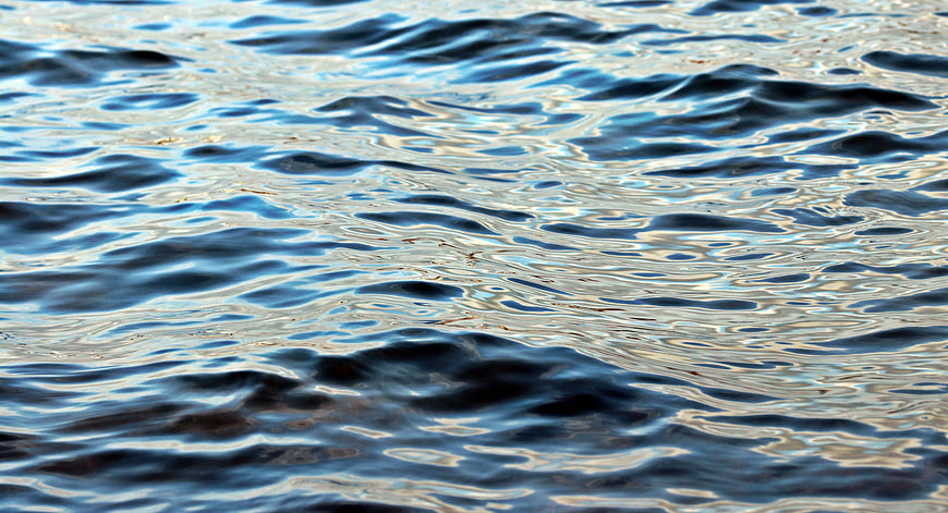 Close-up of rippling blue water surface with sunlight reflections