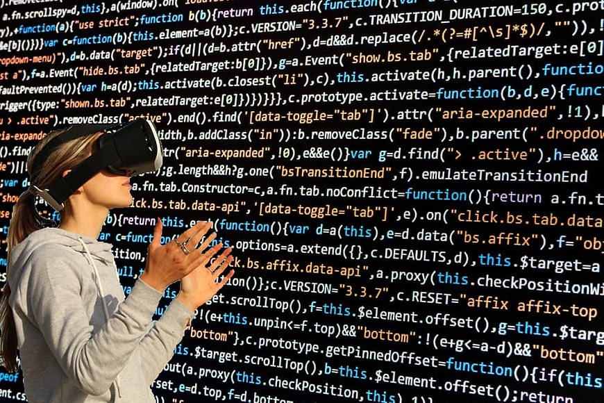 Woman wearing VR headset interacting with virtual code background