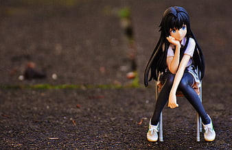 Anime Girl Figure Sitting On Small Chair Outdoors