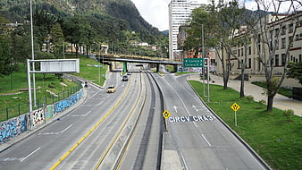 Urban Highway with Tram Tracks and Mountain Backdrop