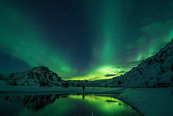 Aurora Borealis Reflection in Snowy Mountain Valley