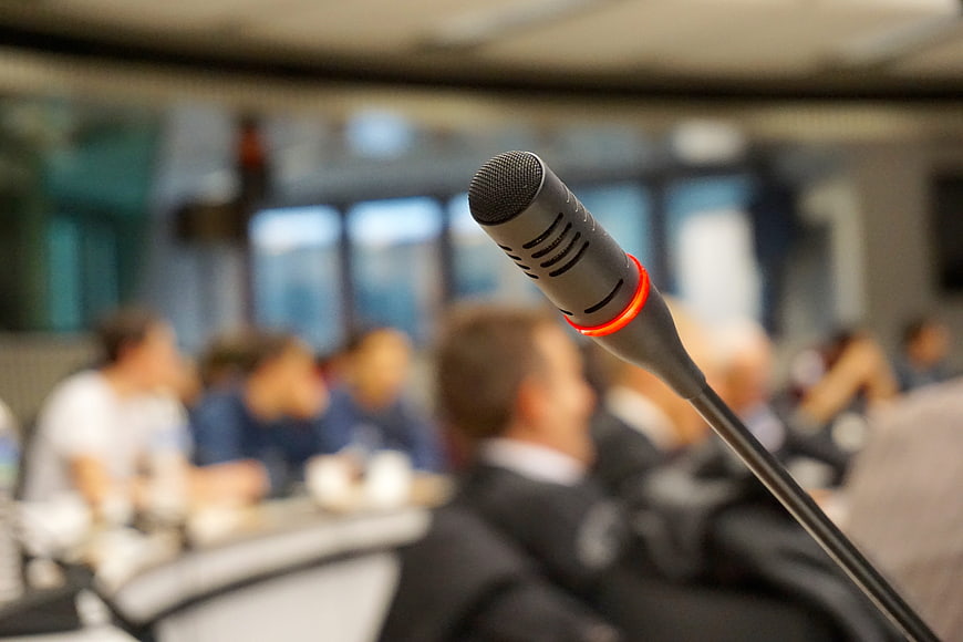 Close-up of active conference microphone with red light