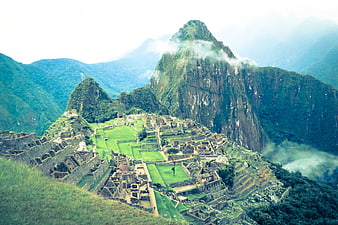 Machu Picchu ruins with Huayna Picchu mountain and mist