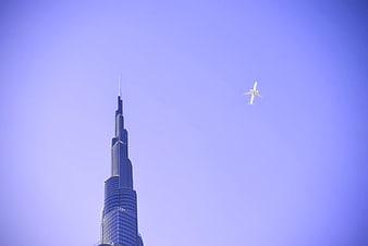 Burj Khalifa and Airplane Against Purple Sky