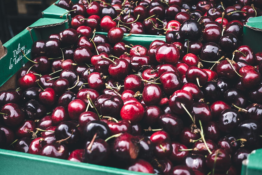Fresh Red Cherries in Green Cardboard Box