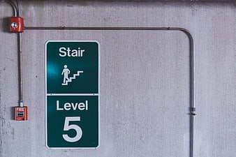 Green Stair Level 5 Sign on Concrete Wall