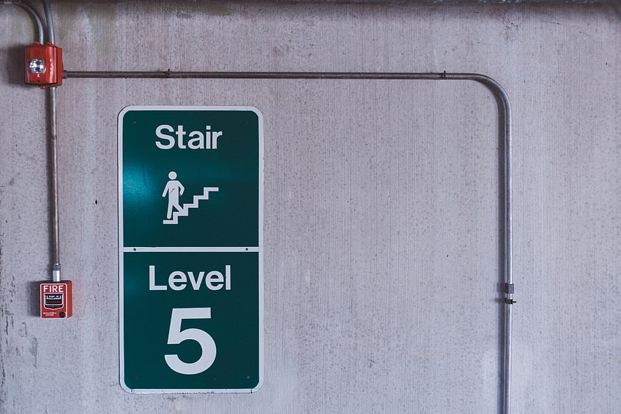 Green Stair Level 5 Sign on Concrete Wall