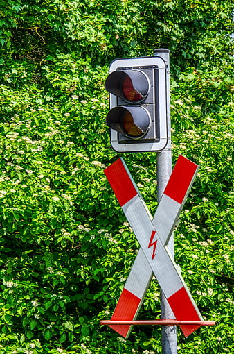 Railroad crossing signal with red lights and crossbuck sign
