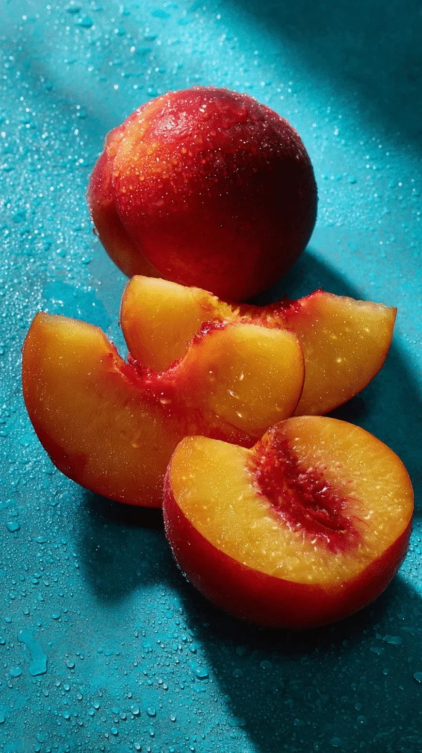 Fresh Juicy Peaches with Water Droplets on Blue Background