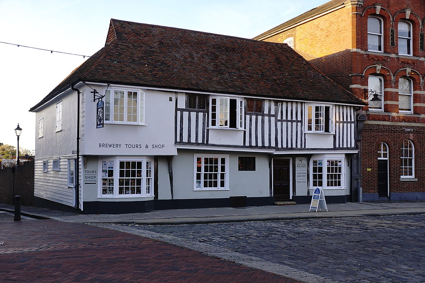 Historic Tudor-style brewery building on cobblestone street