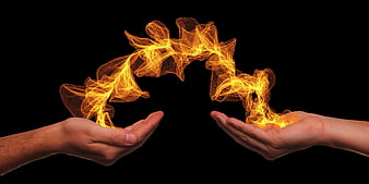 Two hands exchanging glowing orange energy particles on black background