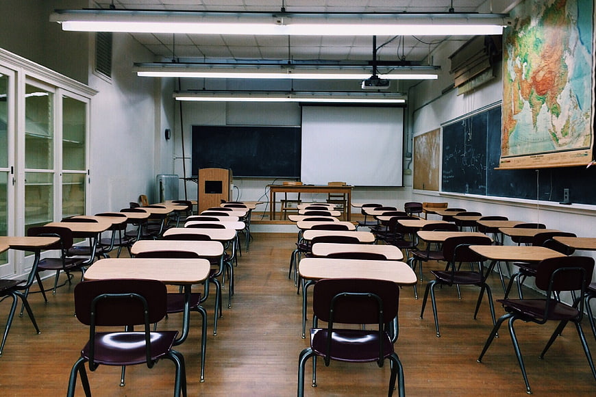 Empty Classroom with Rows of Desks and Blackboard