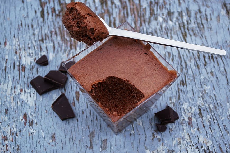 Chocolate Mousse in Glass with Spoon on Blue Wood