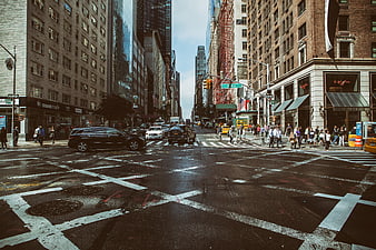Busy New York City Street Intersection with Traffic and Pedestrians