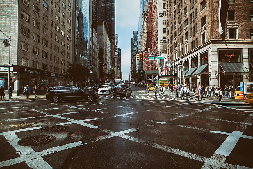 Busy New York City Street Intersection with Traffic and Pedestrians