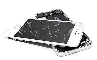 Broken white smartphone with cracked screen on white background