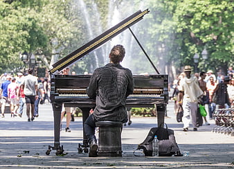 Man playing grand piano in Washington Square Park