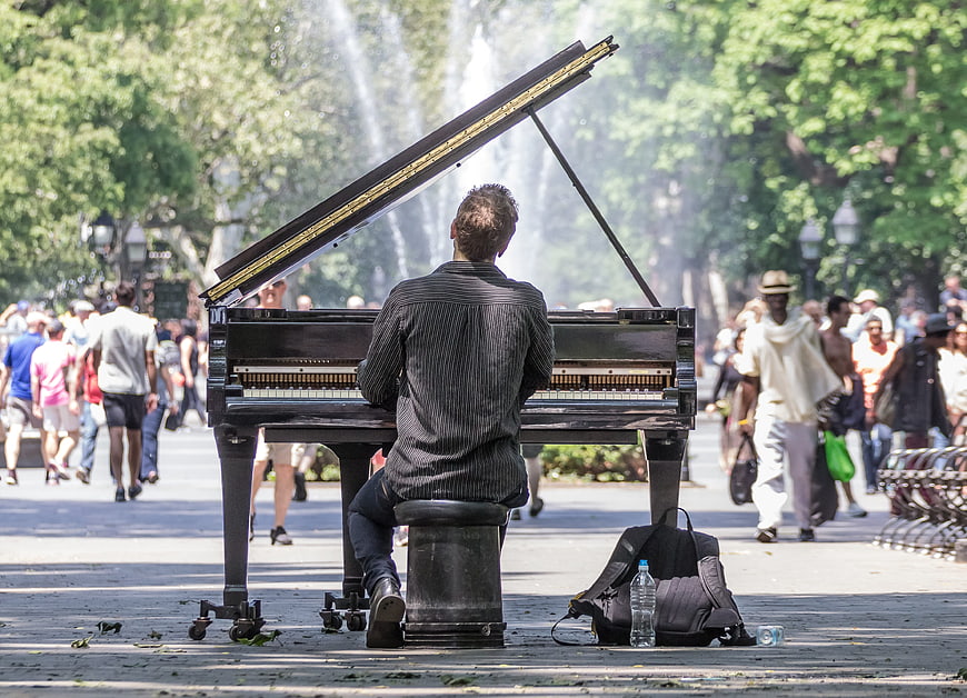 Man playing grand piano in Washington Square Park