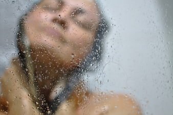 Sensual Woman Bathing Behind Wet Glass