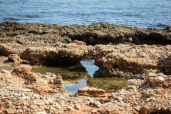 Rugged Rocky Coastline with Tide Pool and Blue Ocean