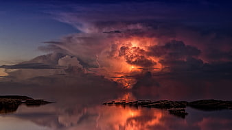 Dramatic Lightning Storm Over Calm Ocean at Twilight