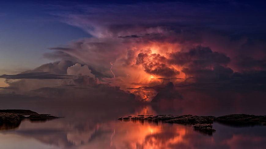 Dramatic Lightning Storm Over Calm Ocean at Twilight