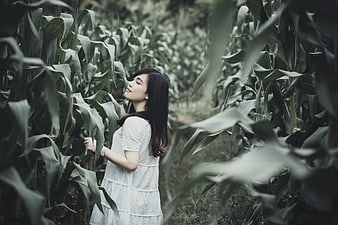 Woman in White Dress Standing in Cornfield