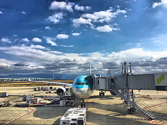 Korean Air Airliner Parked At Airport Gate With Jet Bridge