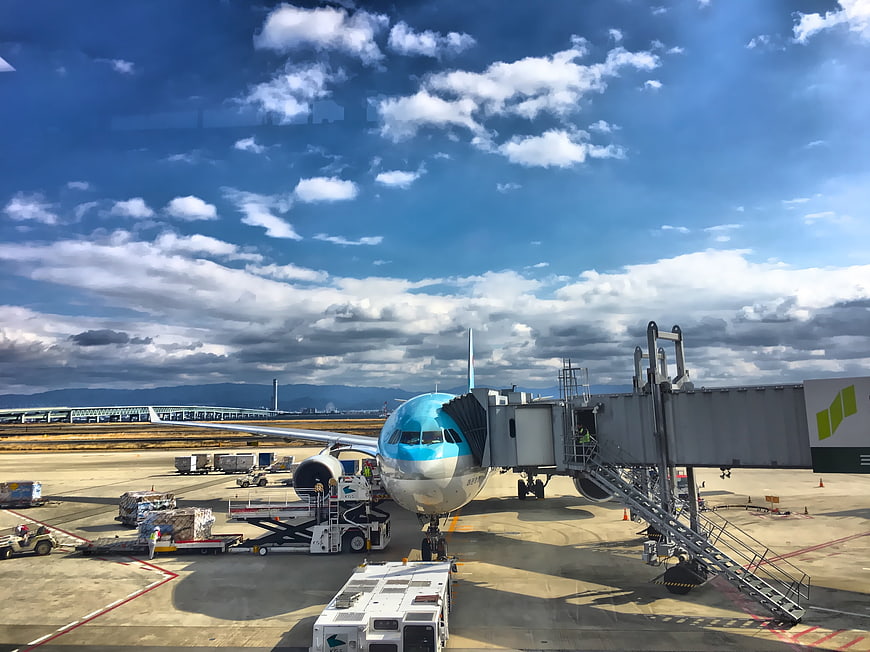 Korean Air Airliner Parked At Airport Gate With Jet Bridge