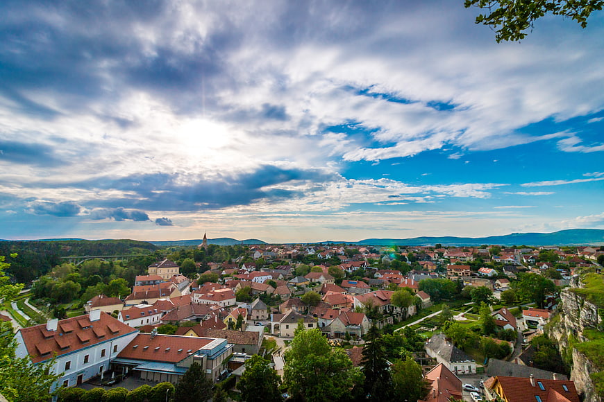 Panoramic View of European Town with Red Roofs and Dramatic Sky
