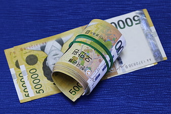 Korean 50,000 Won Banknotes On Blue Fabric