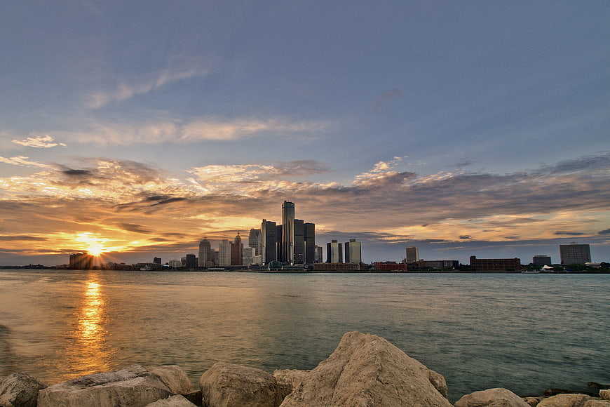Detroit Skyline Sunset View Across The River With Rocks
