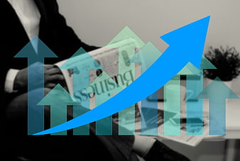 Business growth chart with blue arrow over businessman reading newspaper