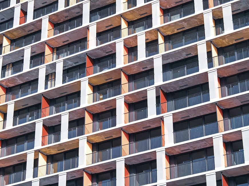 Modern Apartment Building Facade with Orange and White Balconies