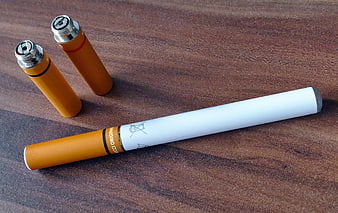 Vaping Device and Cartridges on Wooden Surface