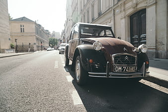 Vintage Citroën 2CV parked on a sunny Parisian street