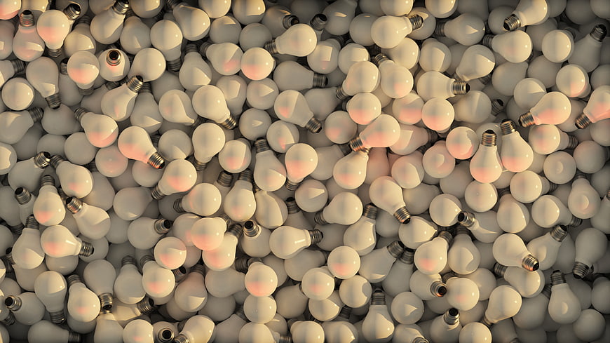 3D Render of Piled White Light Bulbs with Warm Glow