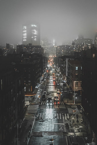 Foggy Night City Street with Wet Asphalt and Traffic Lights