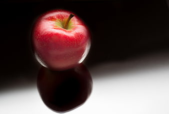 Shiny Red Apple with Reflection on Dark Background