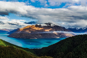 Sunlit Brown Mountain Island in Turquoise Lake