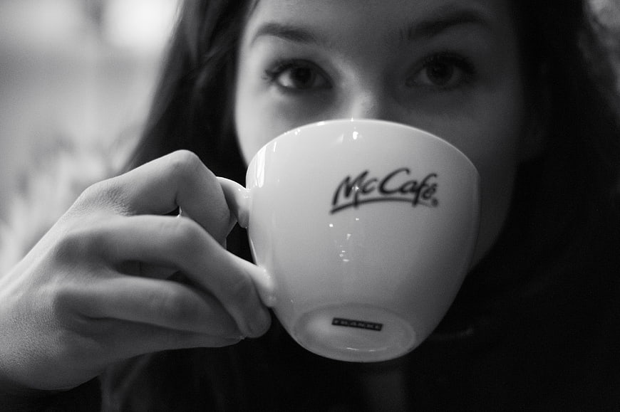 Woman drinking McCafe coffee in black and white