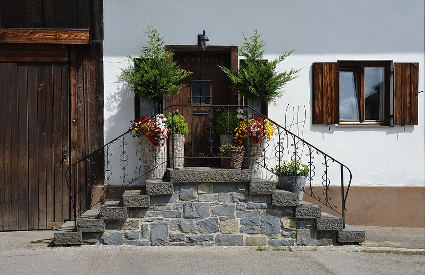 Rustic Wooden Door with Stone Steps and Flower Pots