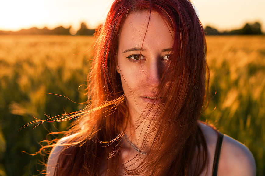 Portrait of Redhead Woman in Golden Wheat Field