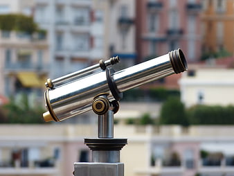 Stainless steel coin-operated telescope on a city street